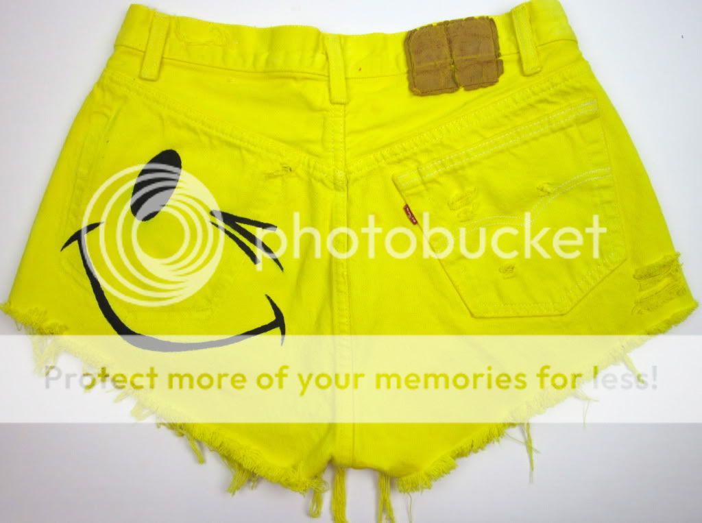   yellow dyed with winking smiley printed on back with the pocket ripped